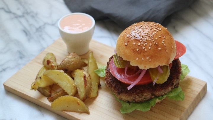 Veggie burger with potato wedges and sriracha&nbsp;mayo